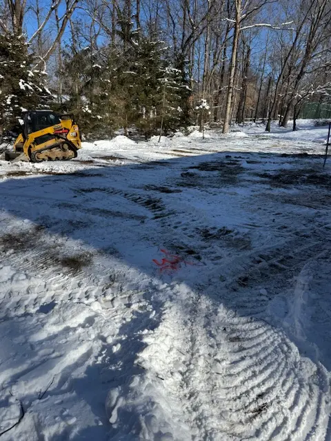 Excavator clearing a residential lot for site work