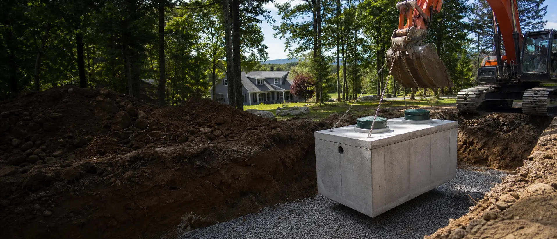 Excavator setting septic tank — open trench